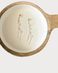 Gold daisy tassel drop earrings from Favored And Common in NC