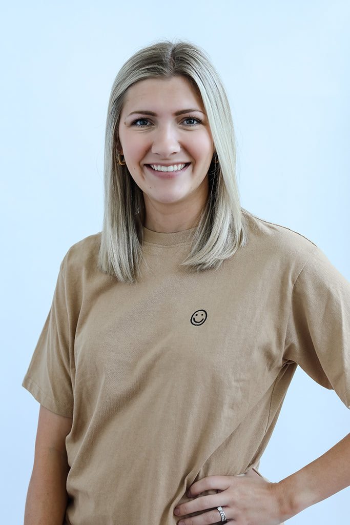 Camel tee with black embroidered smiley face from Favored And Common in NC