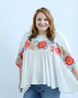 Flowy blouse with embroidery details from Favored And Common online boutique