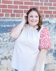 High ruffle neck blouse with pink and red floral sleeves from Favored And Common in NC