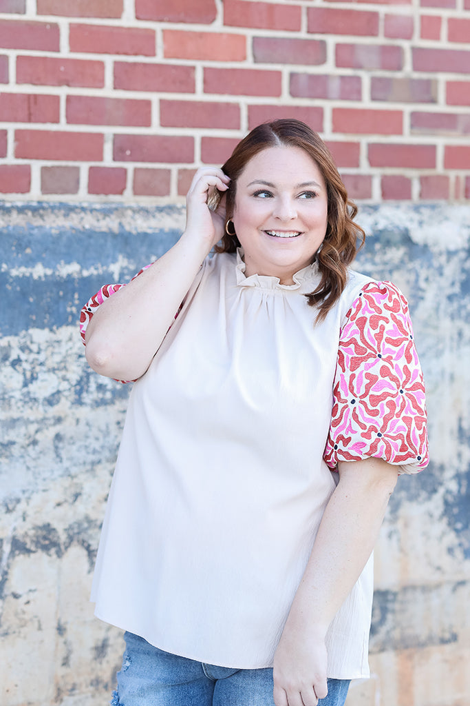 High ruffle neck blouse with pink and red floral sleeves from Favored And Common in NC