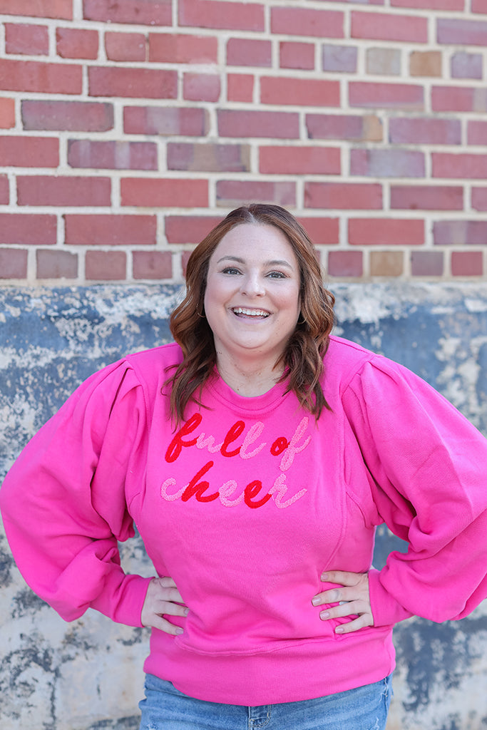 Hot pink Christmas sweatshirt with chenille lettering from Favored And Common in NC