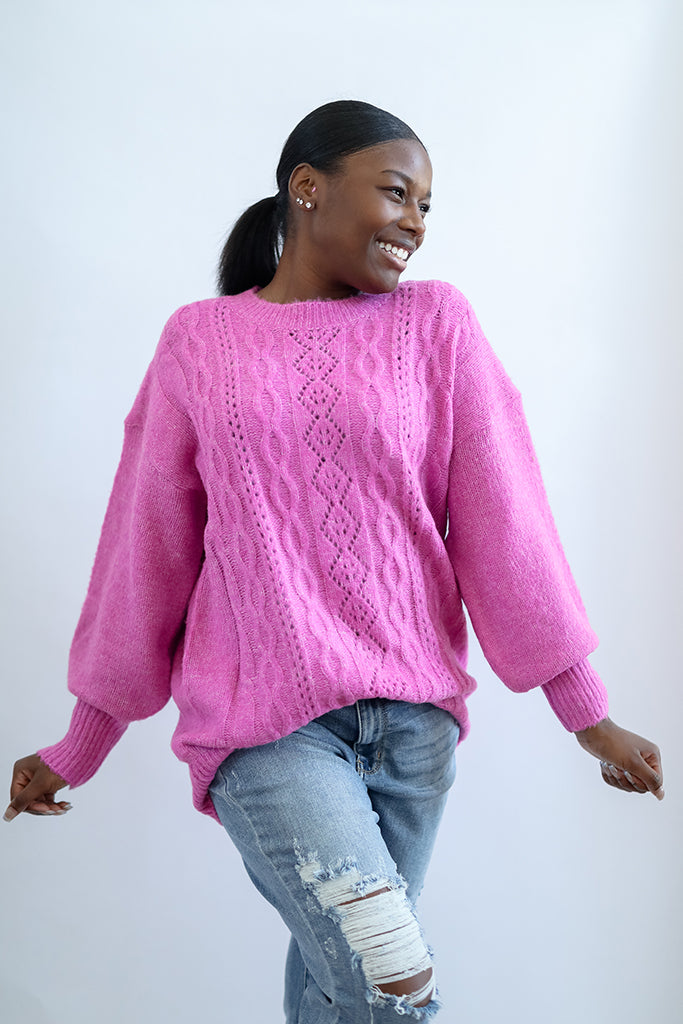 Hot pink cable knit sweater with crew neck and ribbed sleeve cuffs from Favored and Common