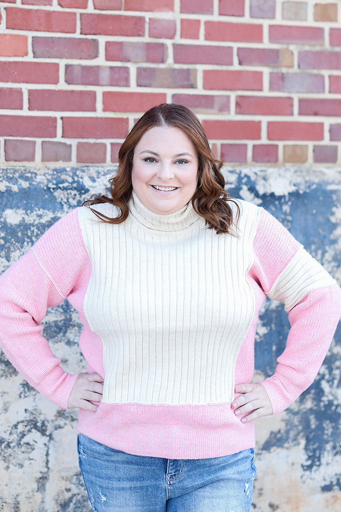 Pink and ivory color block turtle neck from Favored And Common in NC