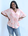 Pink and purple bell sleeve blouse from Favored And Common in NC