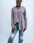 Pink and purple distressed flannel shacket from Favored and Common