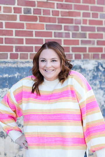 Hot pink and yellow striped sweater from Favored And Common in NC