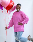 Pink cable knit sweater from Favored and Common in NC