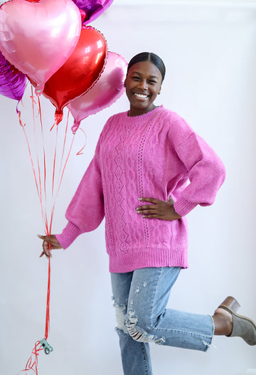 Pink cable knit sweater from Favored and Common in NC