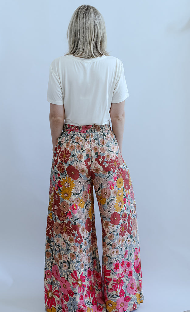 Pink floral flowy pants with smocked waist from Favored And Common