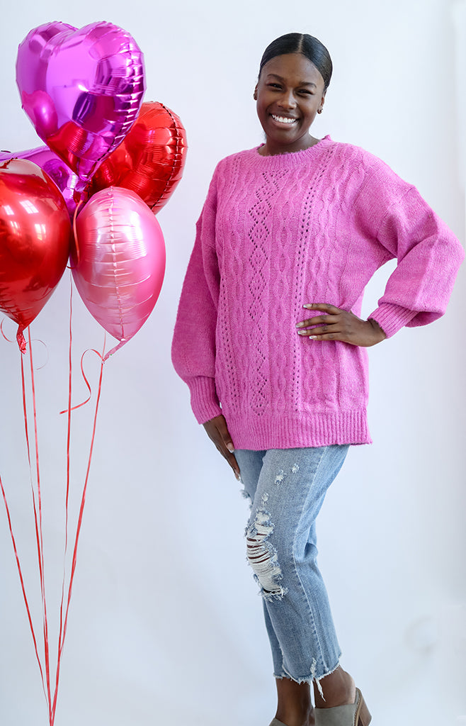 Pink oversized cable knit sweater from Favored and Common