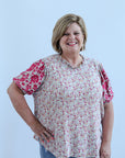 Sage green and pink floral blouse with embroidered sleeves from Favored And Common