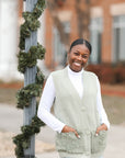 Sage green sweater vest with faux fur front pockets from Favored and Common in NC