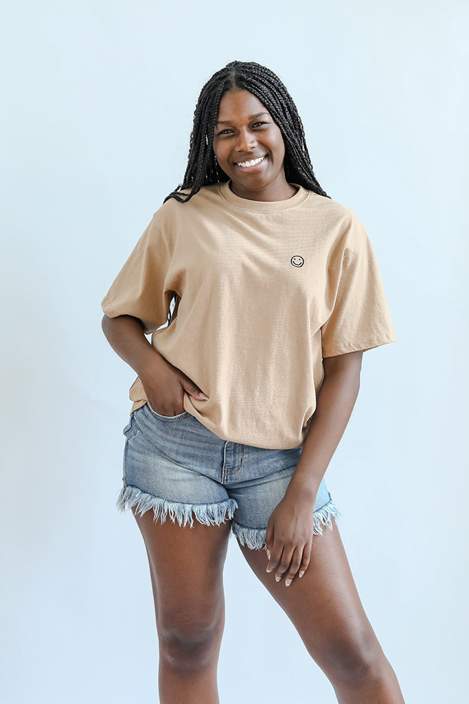 Tan tee with black embroidered smiley face for women from Favored And Common