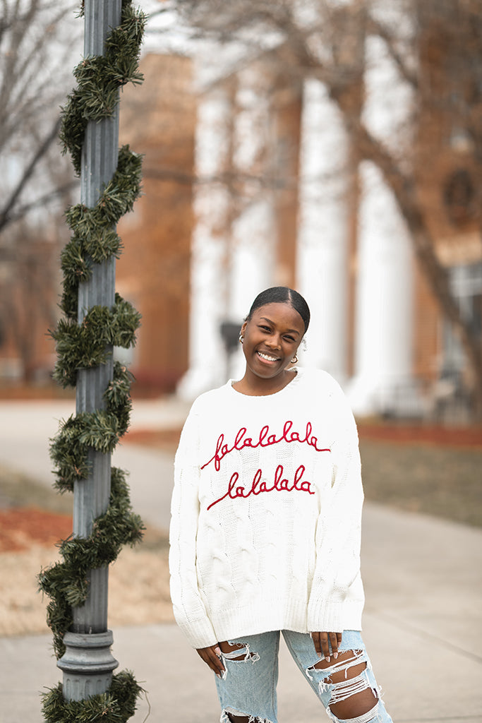 White Falalalala Christmas cable knit sweater from Favored And Common