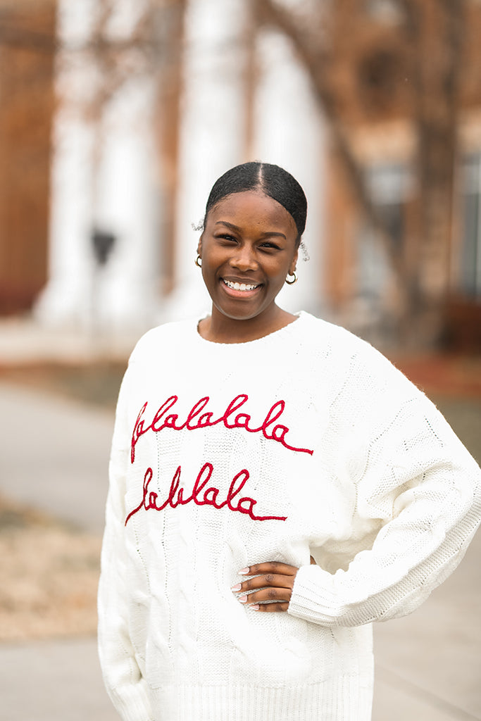 White cable knit sweater with red embroidered letters from Favored And Common