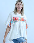 White flowy embroidered blouse with side slits from Favored And Common