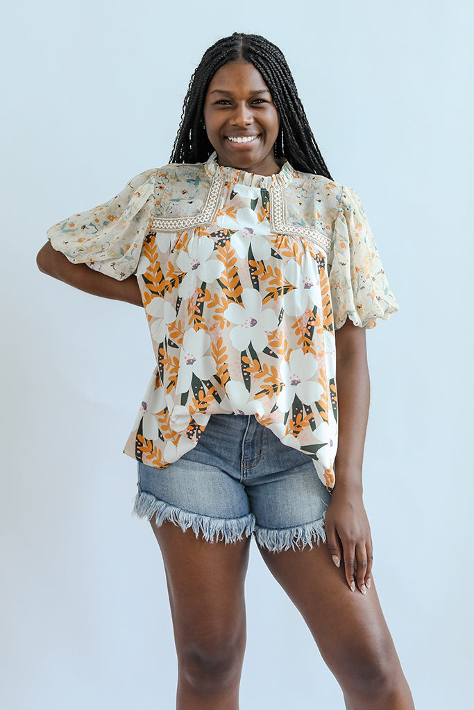 Yellow flowy floral high neck blouse from Favored And Common in NC