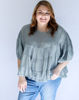 Steele blue flowy tiered blouse from Favored And Common in NC