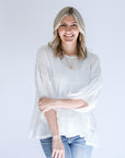 White flowy blouse with raw hem from Favored And Common