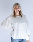 White tiered flowy blouse with bubble sleeves from Favored And Common in NC