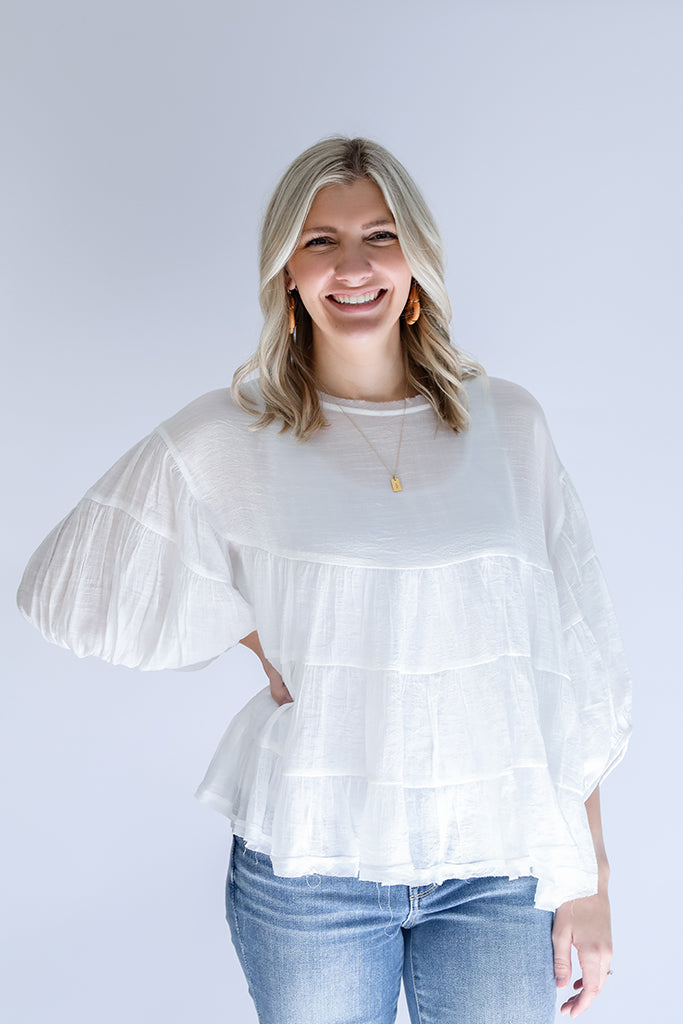 White tiered flowy blouse with bubble sleeves from Favored And Common in NC