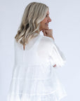 White flowy blouse with key hole back and raw hem from Favored And Common