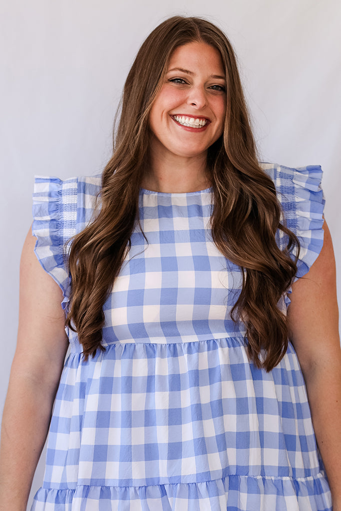 Blue and white tiered mini dress with ruffle sleeves from Favored And Common in NC