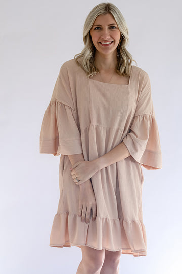 Textured blush pink dress with a square neck line and ruffled hem from Favored And Common