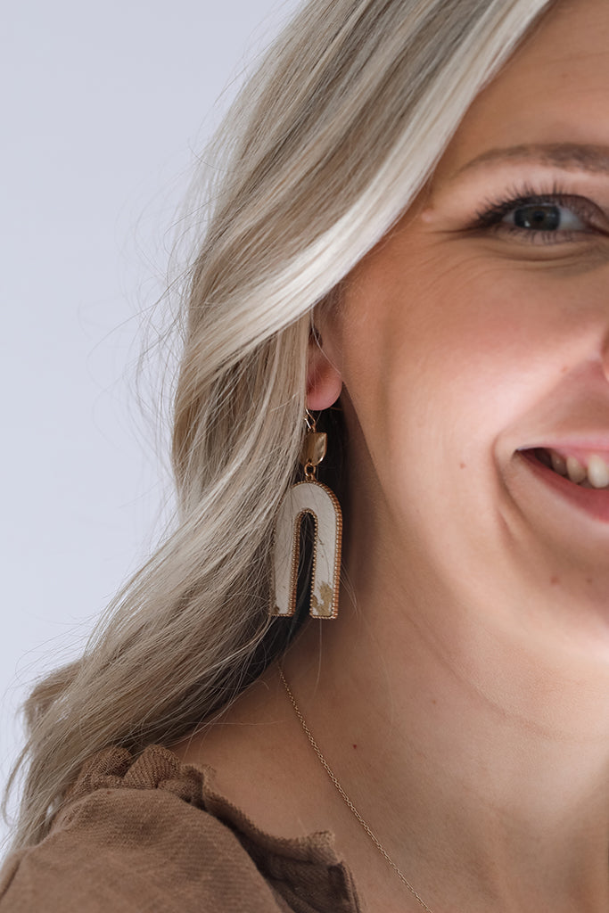 Gold and ivory cow print drop earrings from Favored And Common