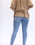 Medium wash cropped skinny jeans with distressed details from Favored and Common