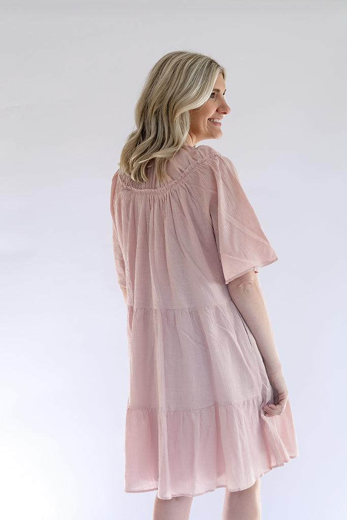 Pink tiered dress with sleeves from Favored And Common in NC