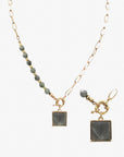 Gold chain necklace with grey beaded accents and square charm from Favored And Common