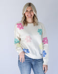 White knit daisy print sweater outfit from Favored And Common in NC