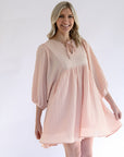 Women's pink flowy textured mini dress with front tie from Favored and Common in NC