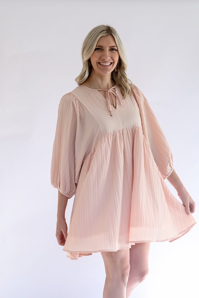 Women's pink flowy textured mini dress with front tie from Favored and Common in NC